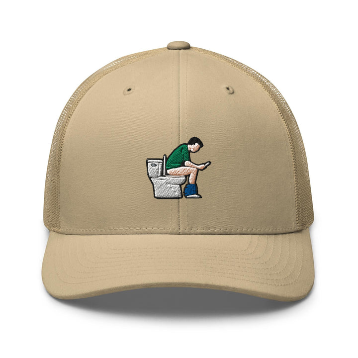 a baseball cap with a man sitting on a toilet