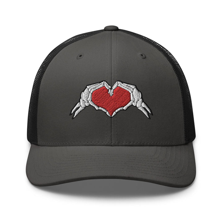 a gray and black trucker hat with a red heart