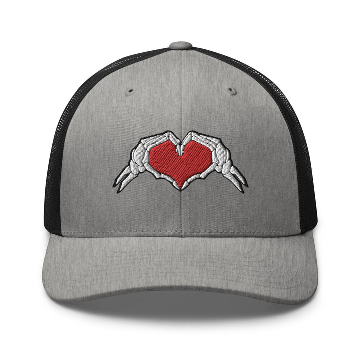 a gray and black trucker hat with a red heart
