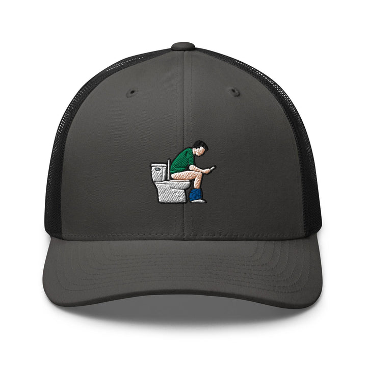 a gray and black hat with a cartoon of a man sitting on a toilet