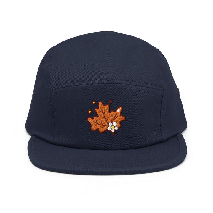 a blue hat with an embroidered maple on it