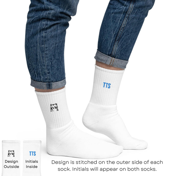 a pair of feet wearing white socks and blue jeans