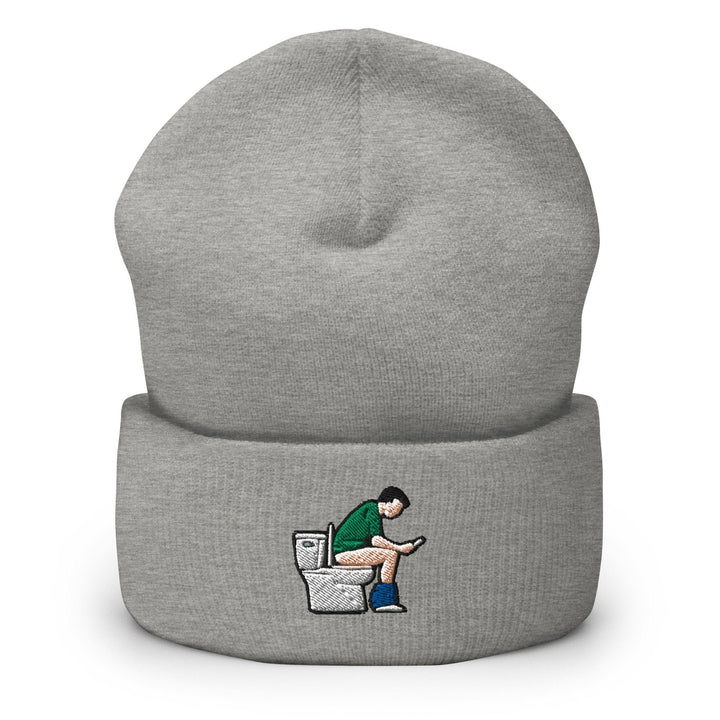 a grey beanie with a cartoon of a man sitting on a toilet