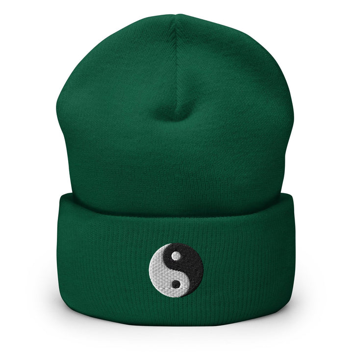a green beanie with a yin symbol on it