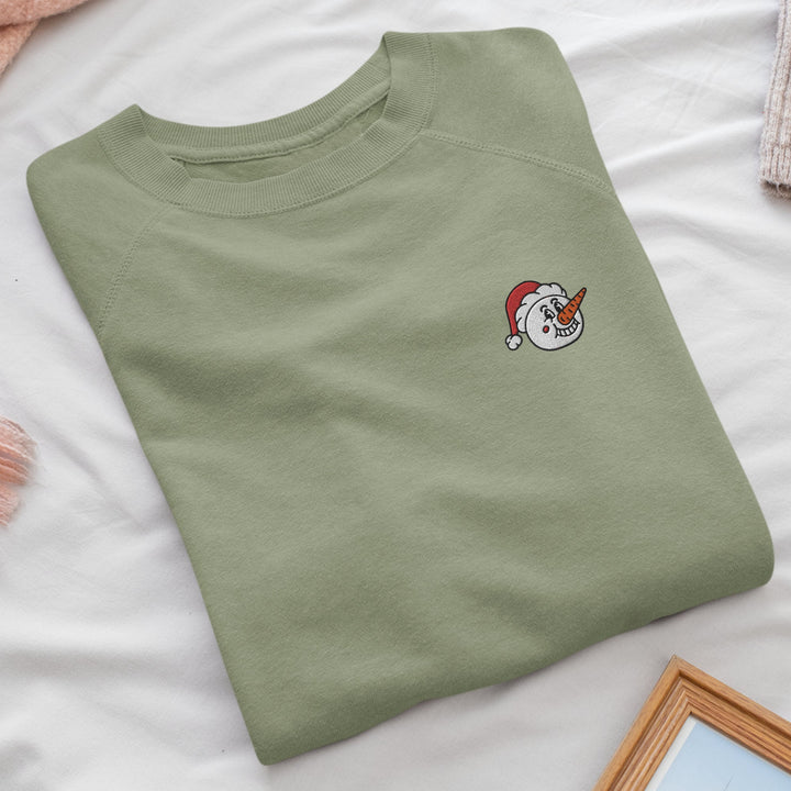a green t - shirt with a unicorn embroidered on it