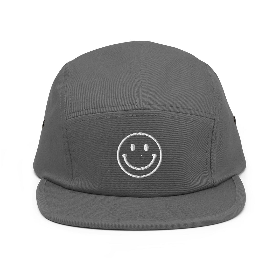 a grey hat with a smiley face on it