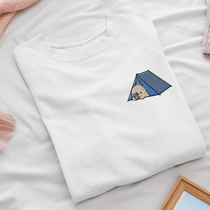 a white t - shirt with a picture of a dog in a tent on it