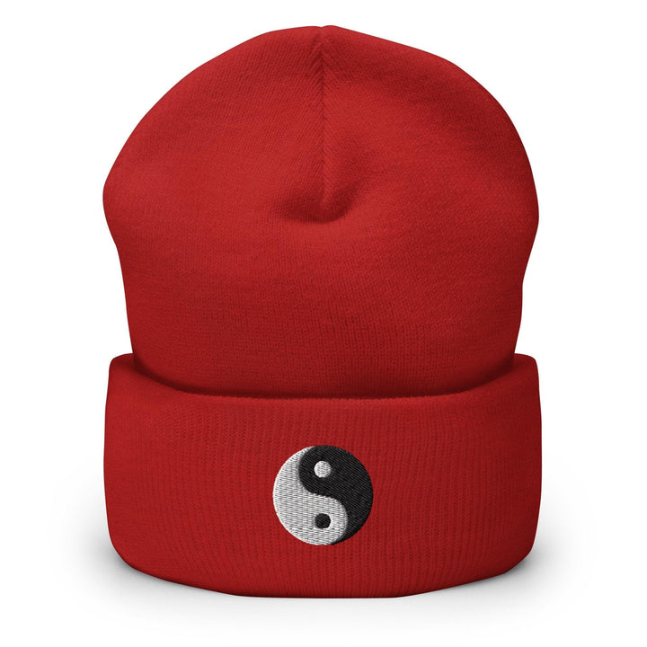 a red beanie hat with a yin symbol on it
