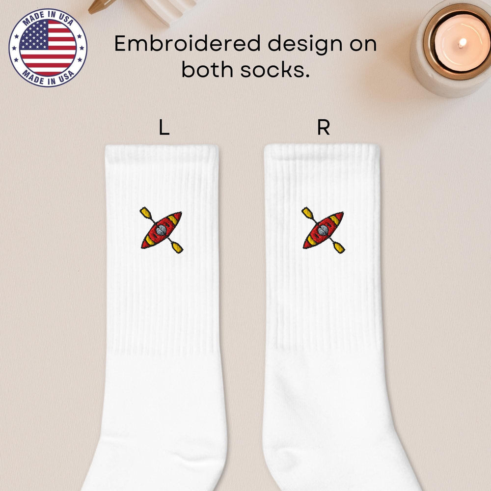 a pair of white socks with a picture of a boat on it