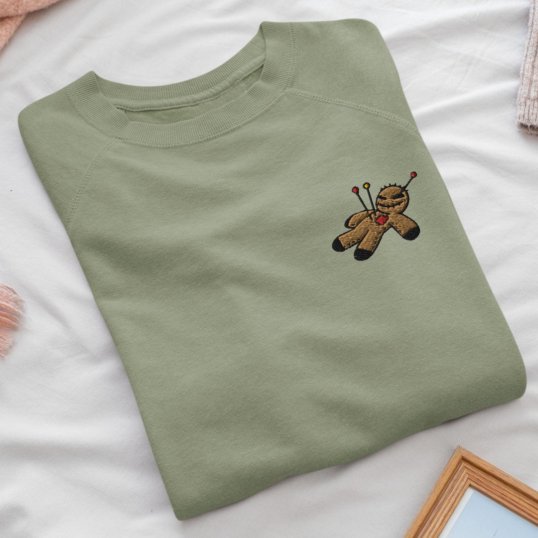 a green t - shirt with a picture of a teddy bear on it