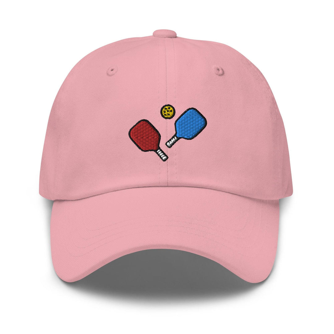a pink hat with two ping pong paddles on it