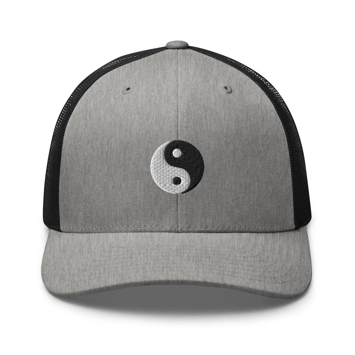 a gray and black hat with a yin symbol on it