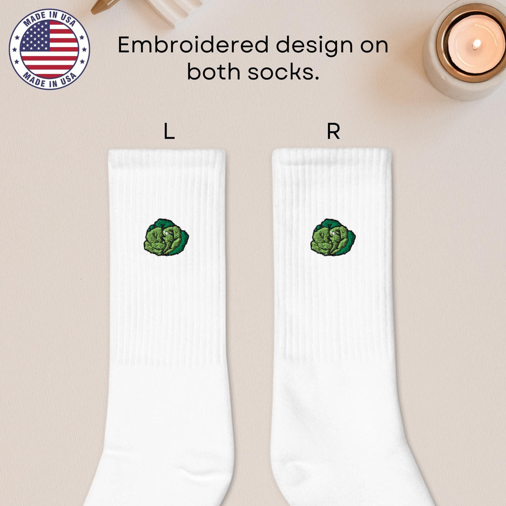 a pair of white socks with a picture of a broccoli on it