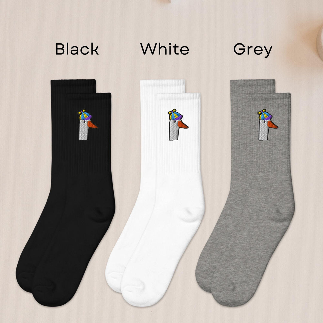 three pairs of black, white, and grey socks