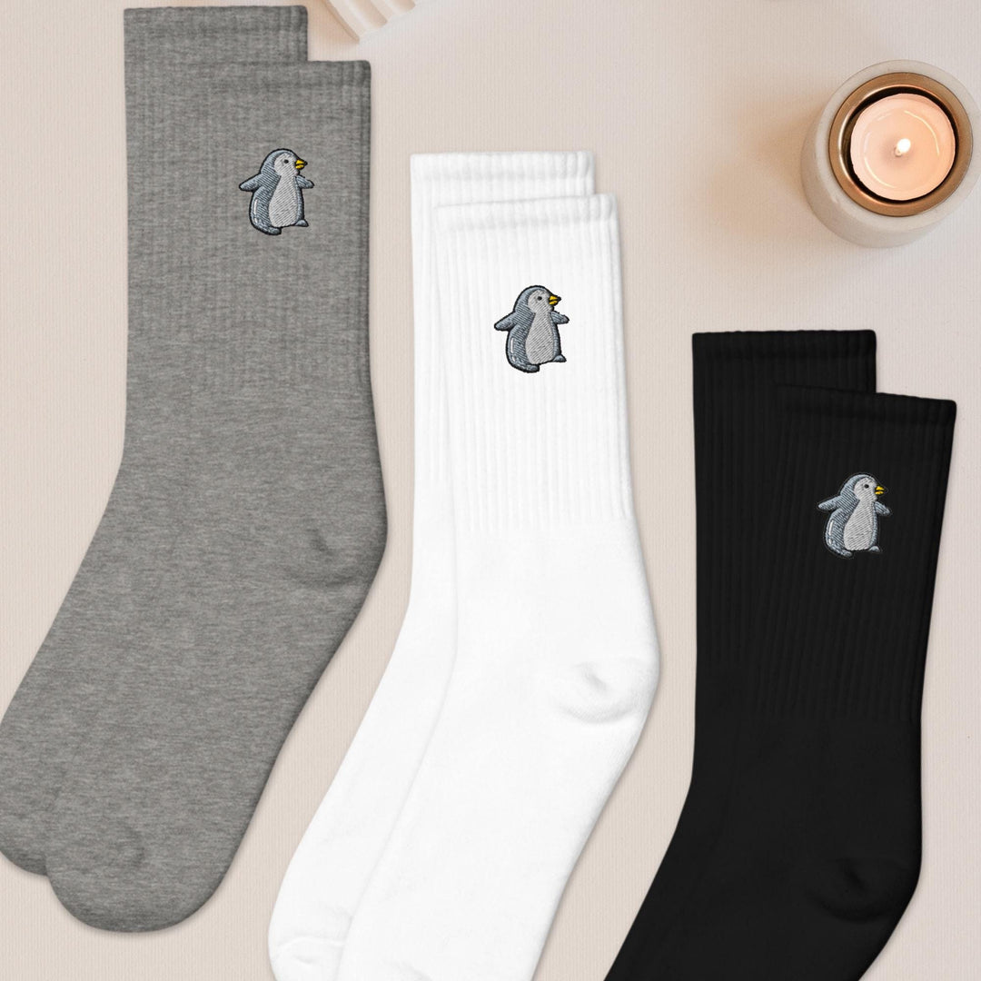 three pairs of socks with penguins on them