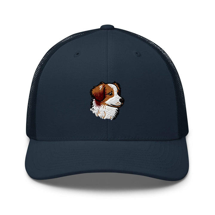 a blue hat with a brown and white dog on it