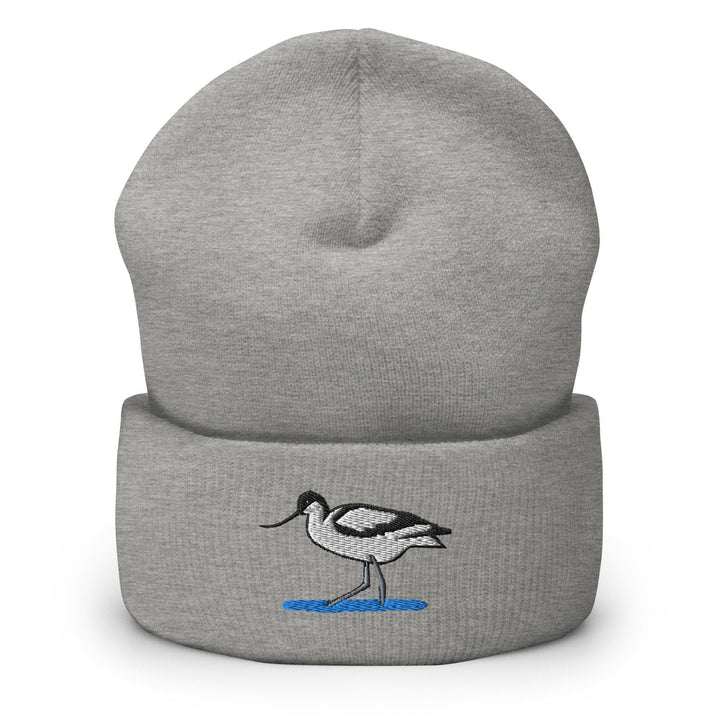 a grey beanie with a black and white bird on it