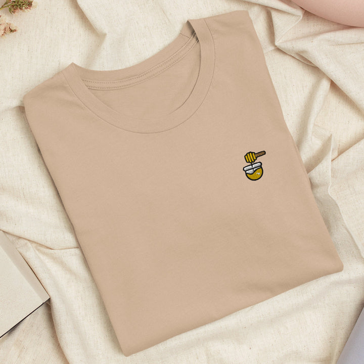 a t - shirt with a bee embroidered on it