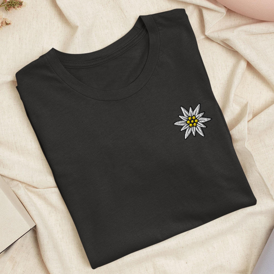 a black t - shirt with a white and yellow flower on it