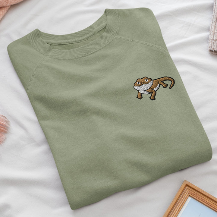 a green t - shirt with a monkey embroidered on it