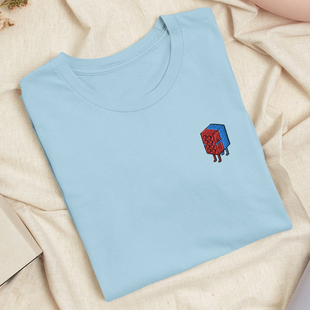 a blue t - shirt with a red cube on it