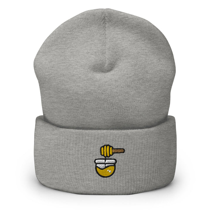 a grey hat with a bee on it
