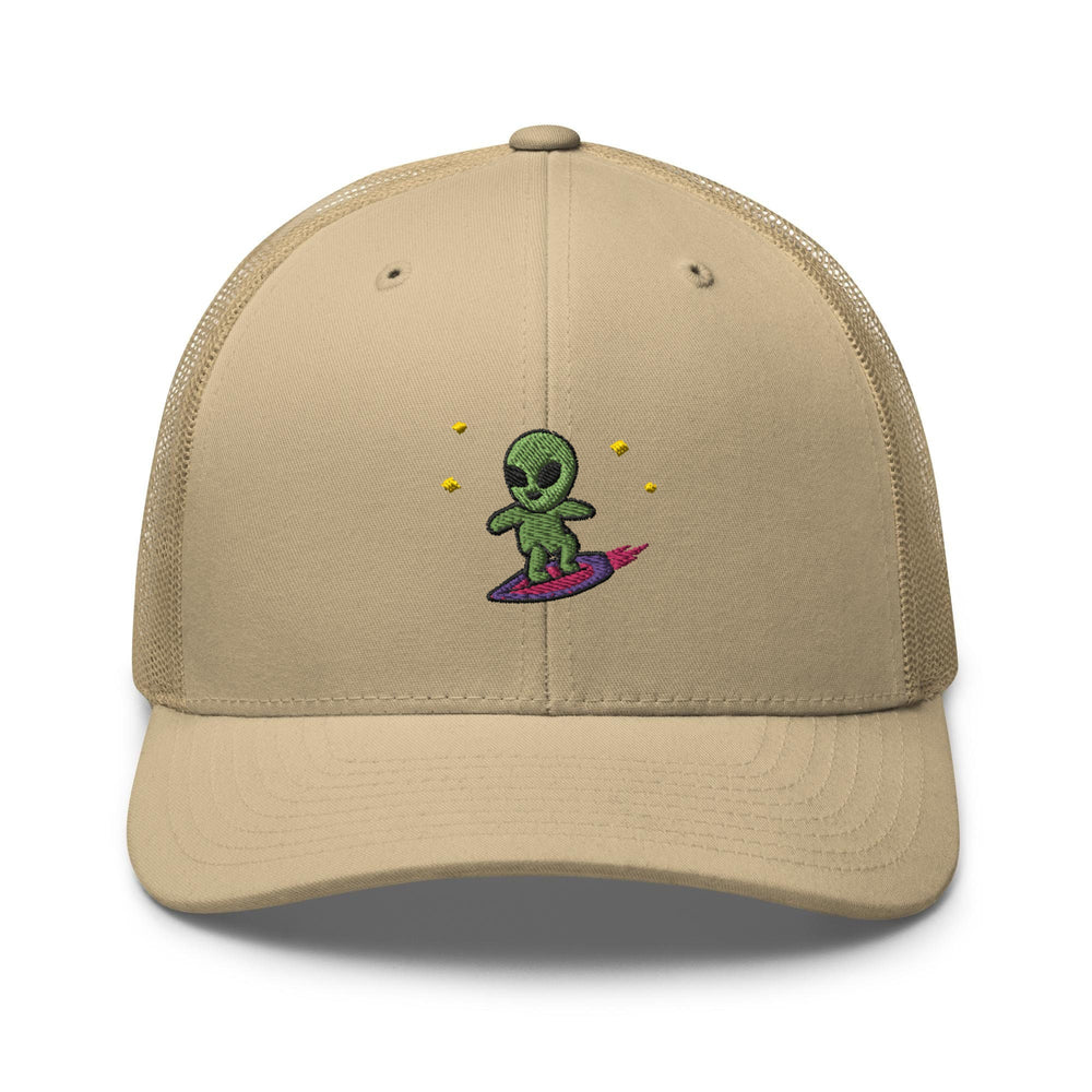 a tan trucker hat with a green alien riding a surfboard
