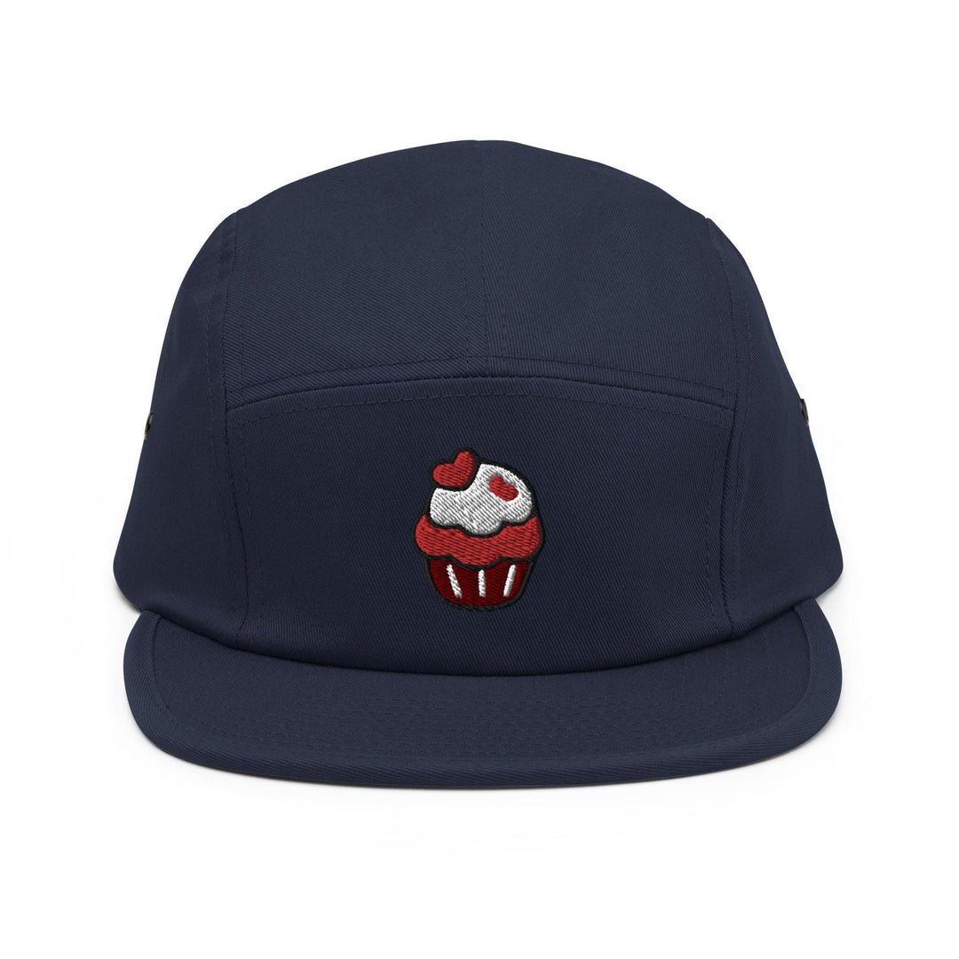 a blue hat with a cupcake embroidered on it