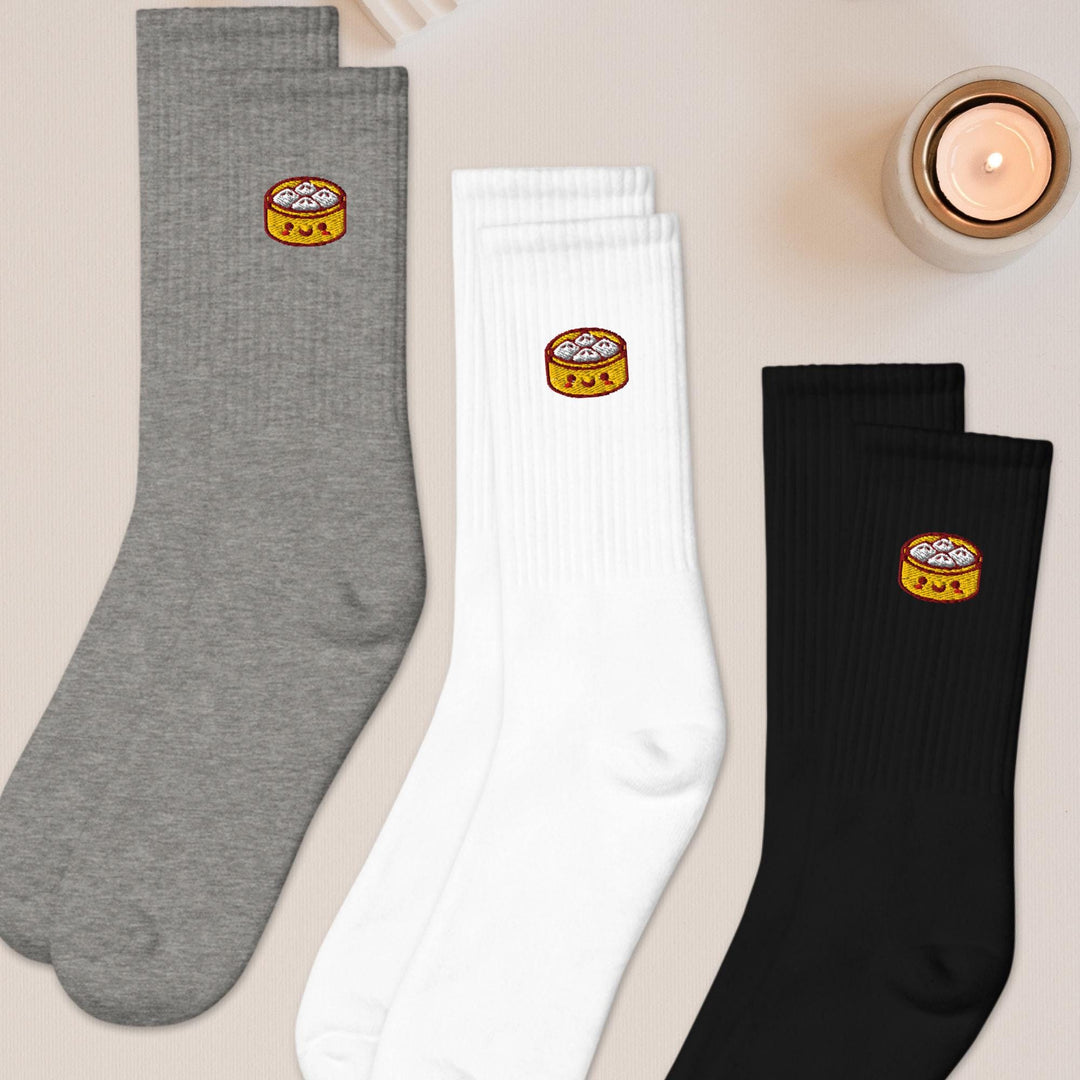 three pairs of socks sitting on top of a table