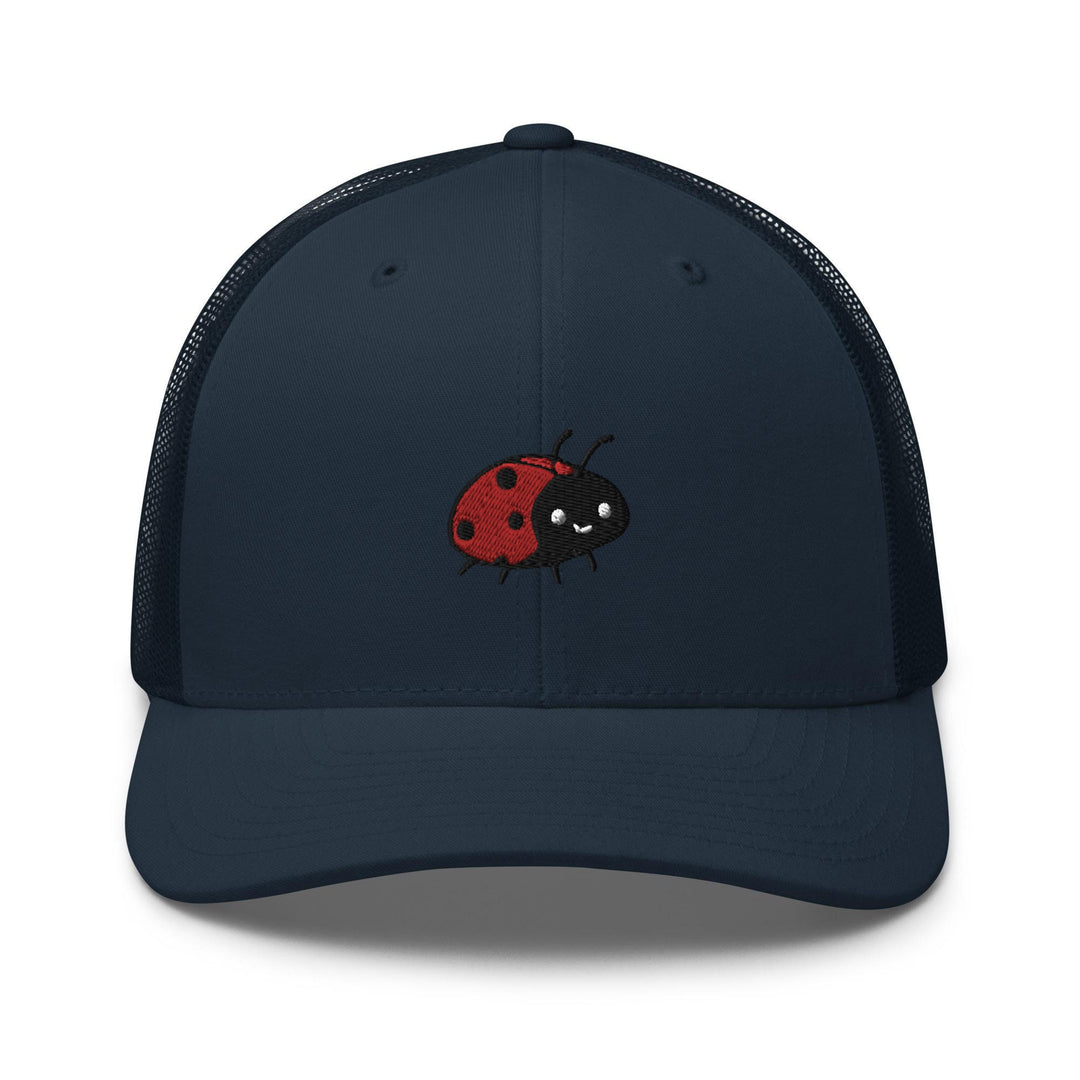 a blue trucker hat with a red ladybug embroidered on the front
