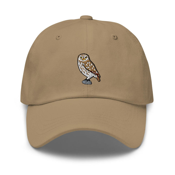 a tan hat with an owl embroidered on it