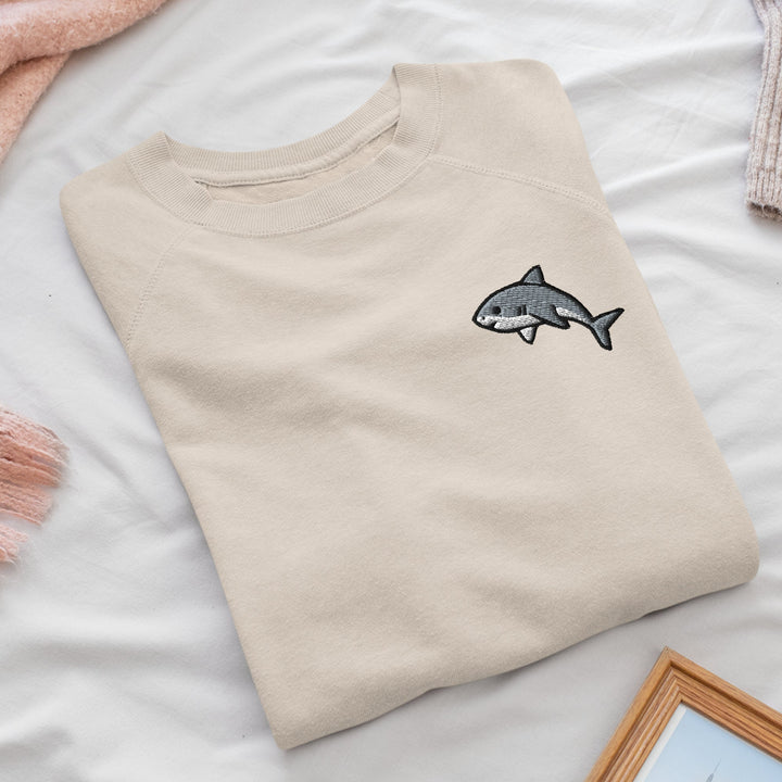 a t - shirt with a shark embroidered on it
