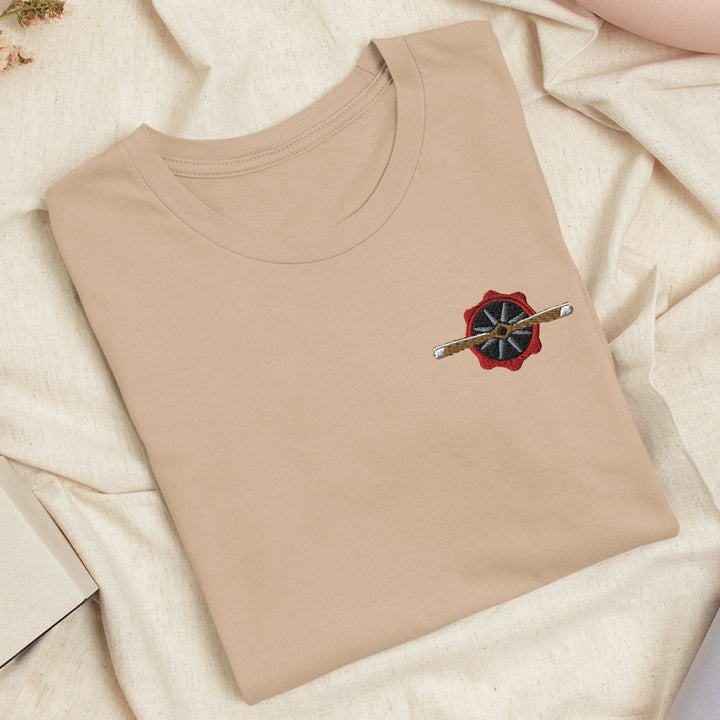 a t - shirt with an umbrella on it laying on a bed