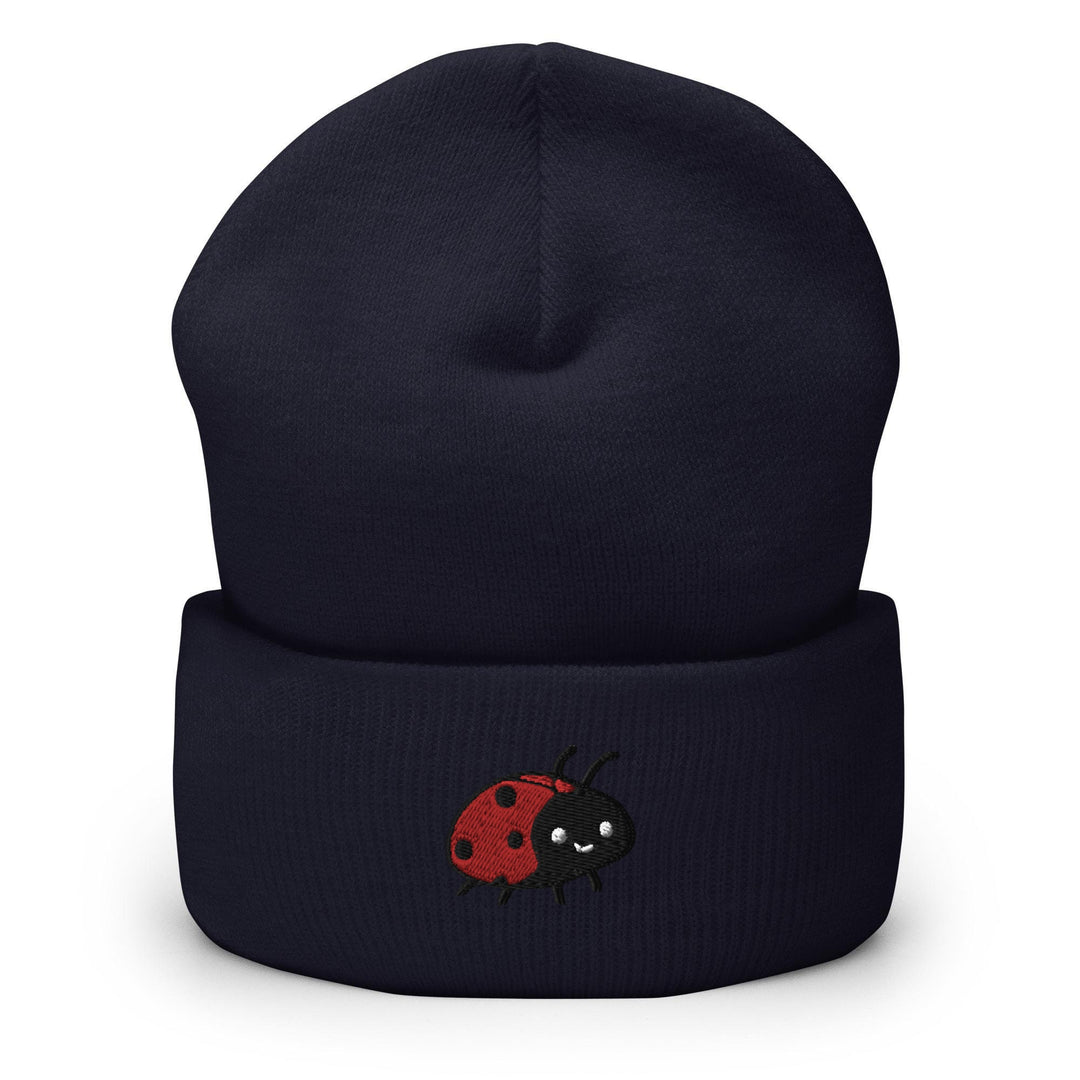 a black beanie with a red ladybug on it