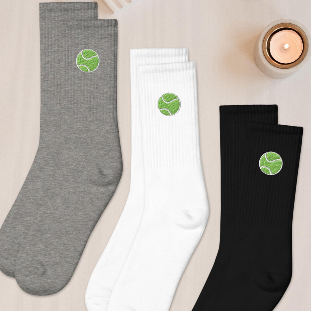 three pairs of tennis socks sitting on top of a table