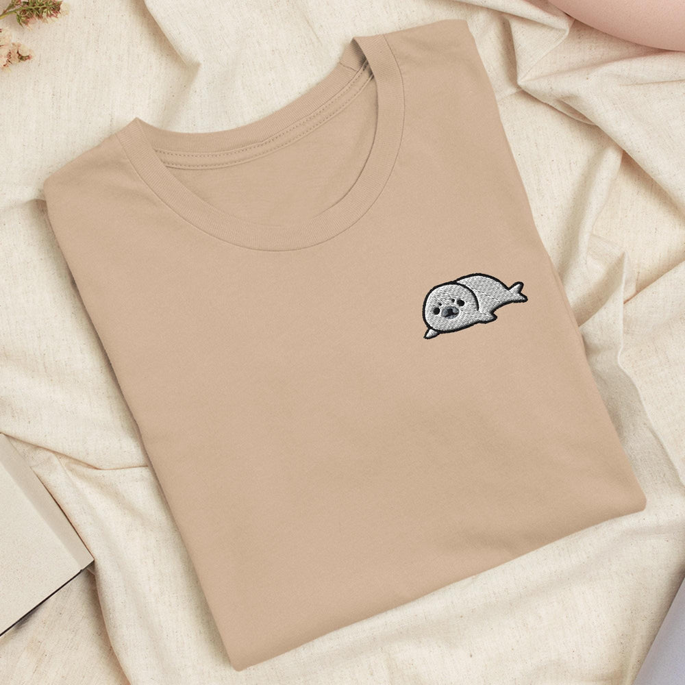 a t - shirt with a ghost on it laying on a bed