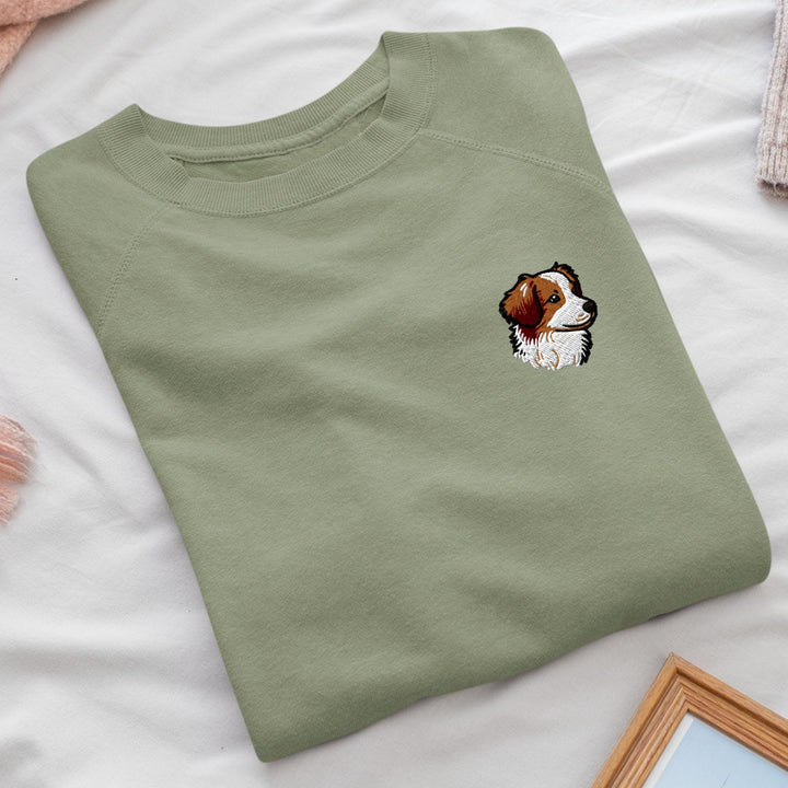 a green shirt with a picture of a dog on it