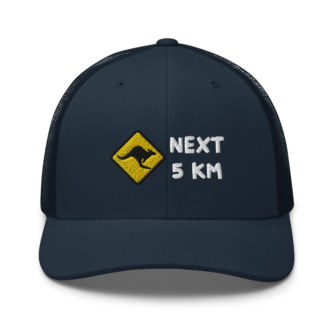 a blue trucker hat with the words next 5 km printed on it