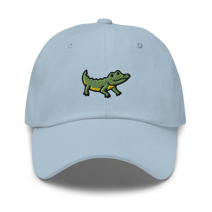 a light blue hat with a green alligator embroidered on the front