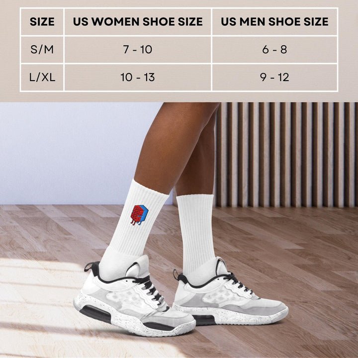 a person wearing white socks and black shoes