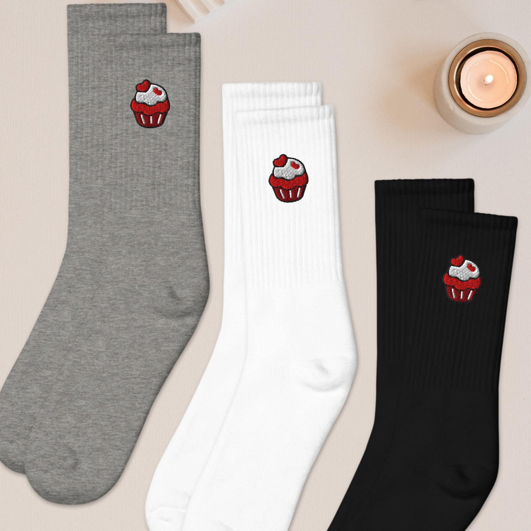 three pairs of socks with cupcakes on them