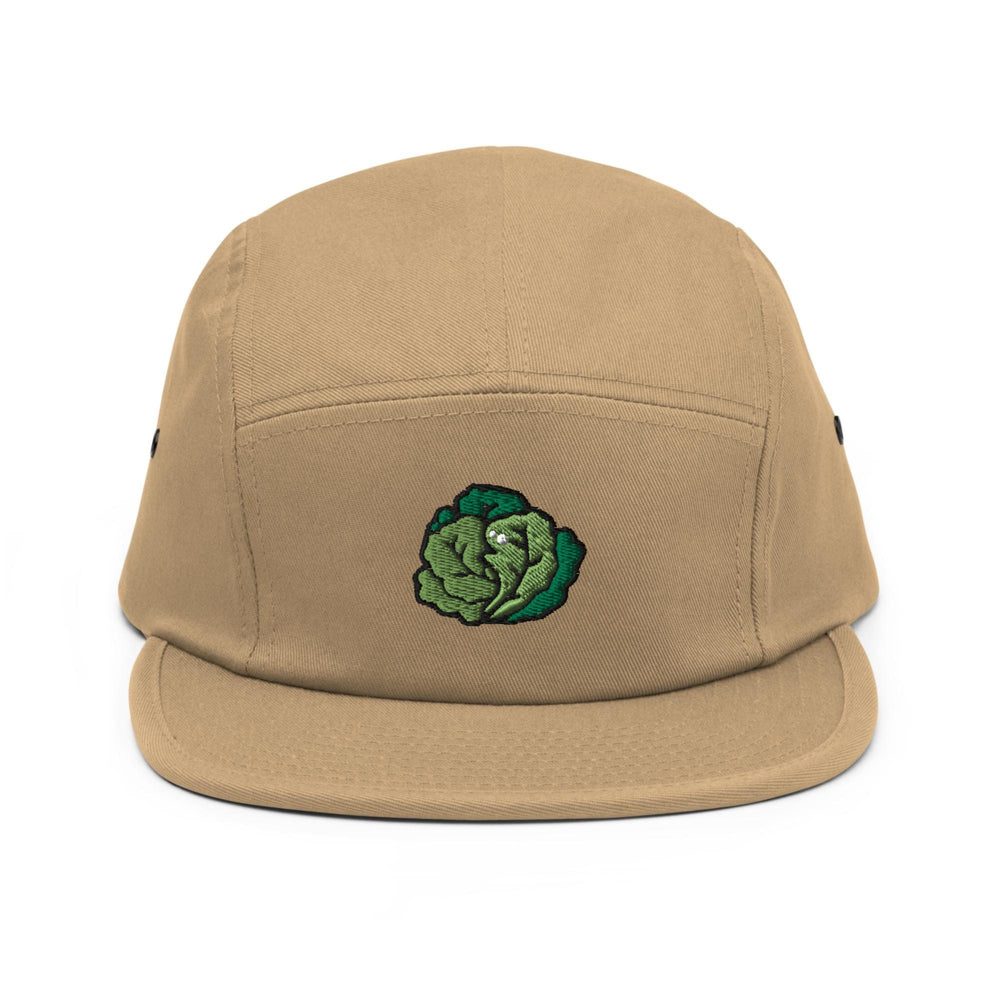 a brown hat with a green flower on it