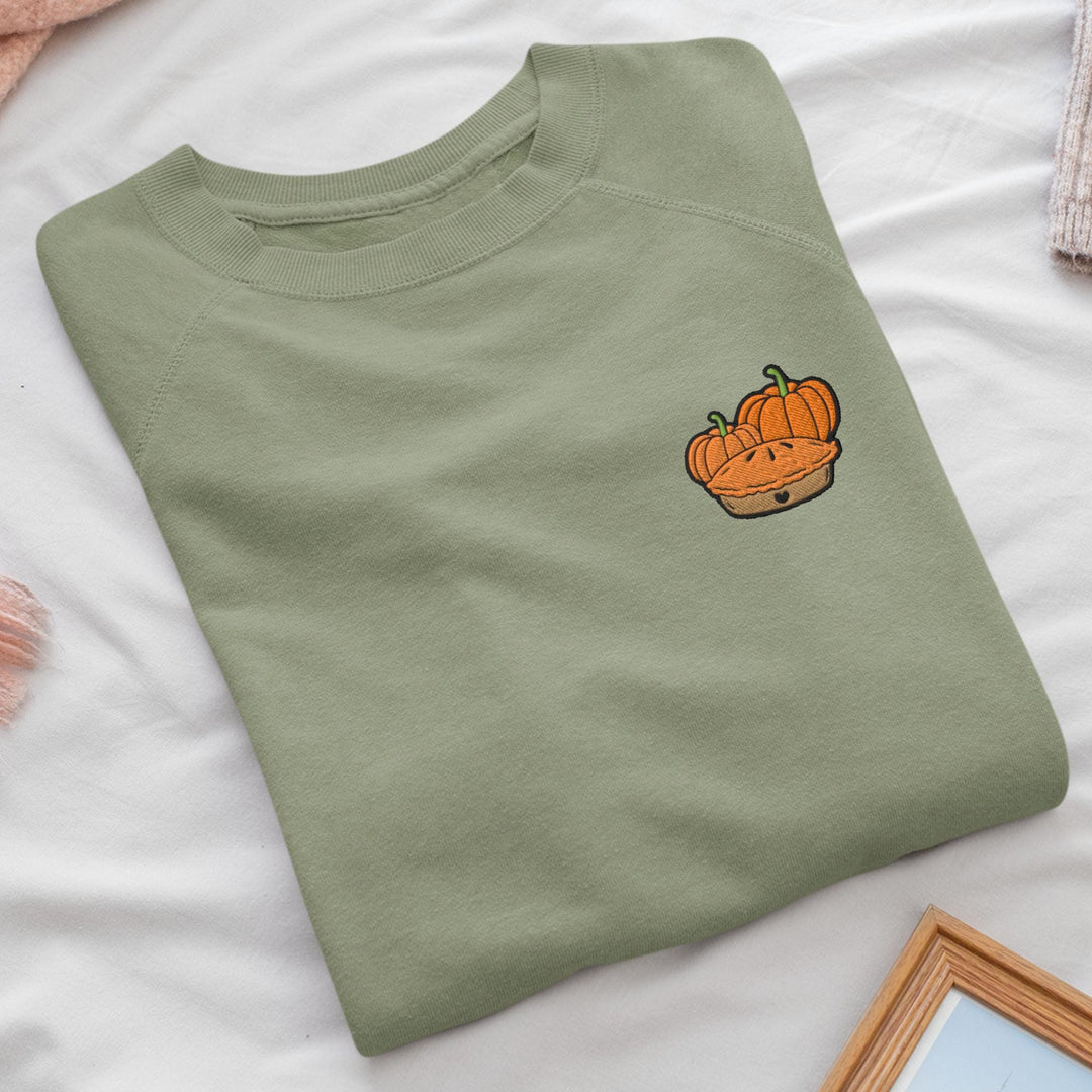 a green shirt with a picture of a pumpkin on it