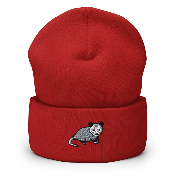 a red beanie with a black and white rat on it