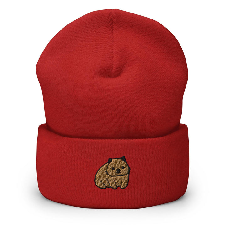 a red beanie with a brown bear embroidered on it