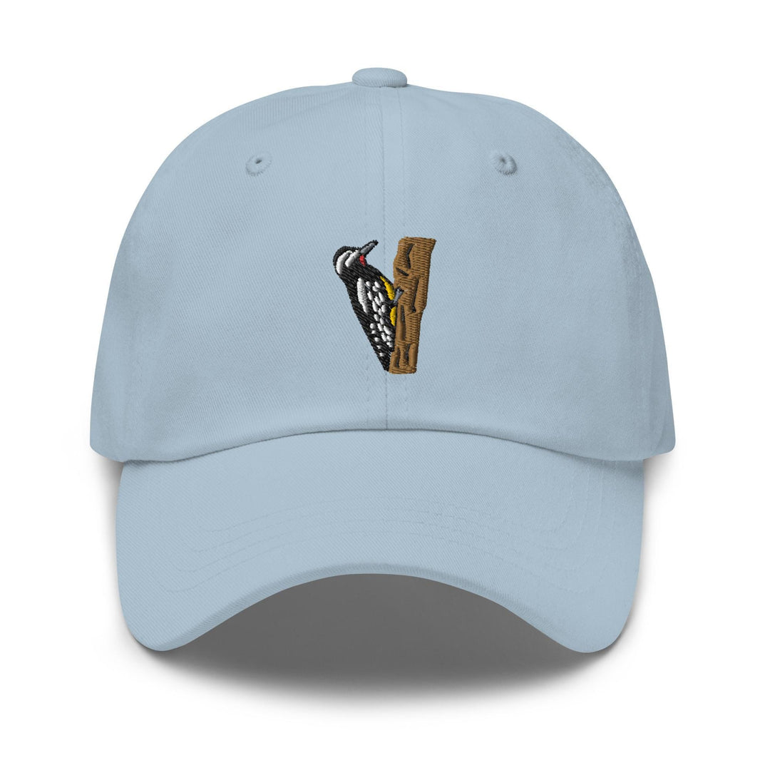 a light blue hat with a bird on it