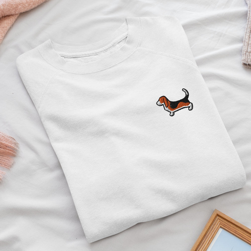 a white t - shirt with a dog embroidered on it