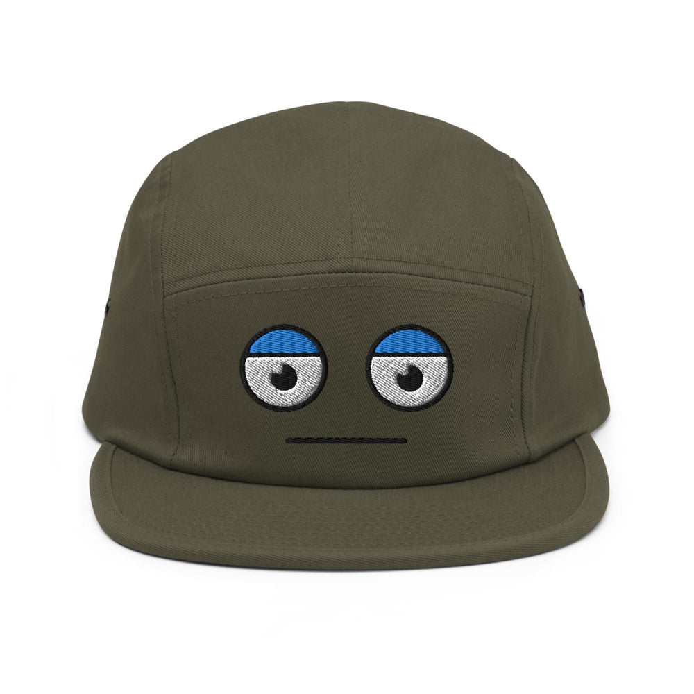 a green hat with eyes drawn on it