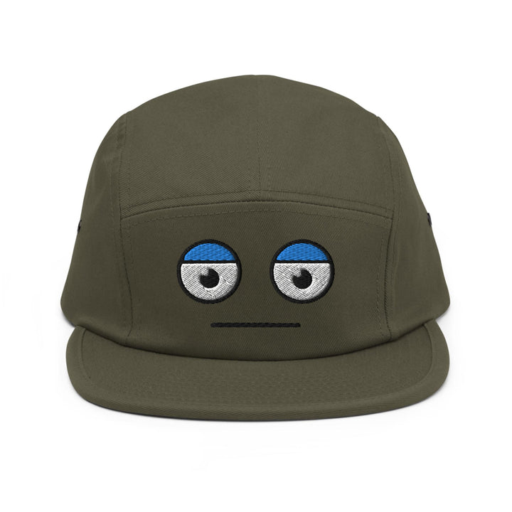 a green hat with eyes drawn on it
