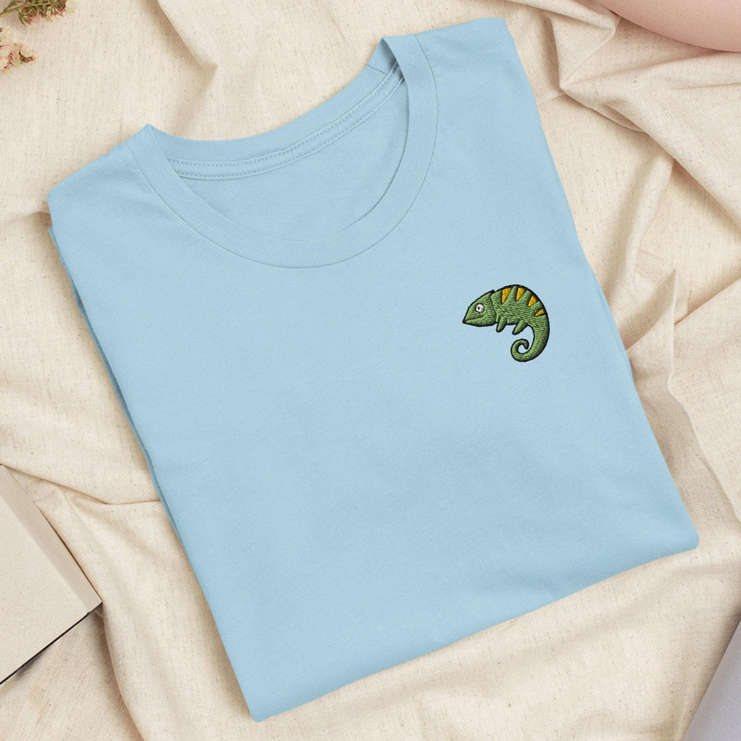 a blue t - shirt with a green chamelon embroidered on it
